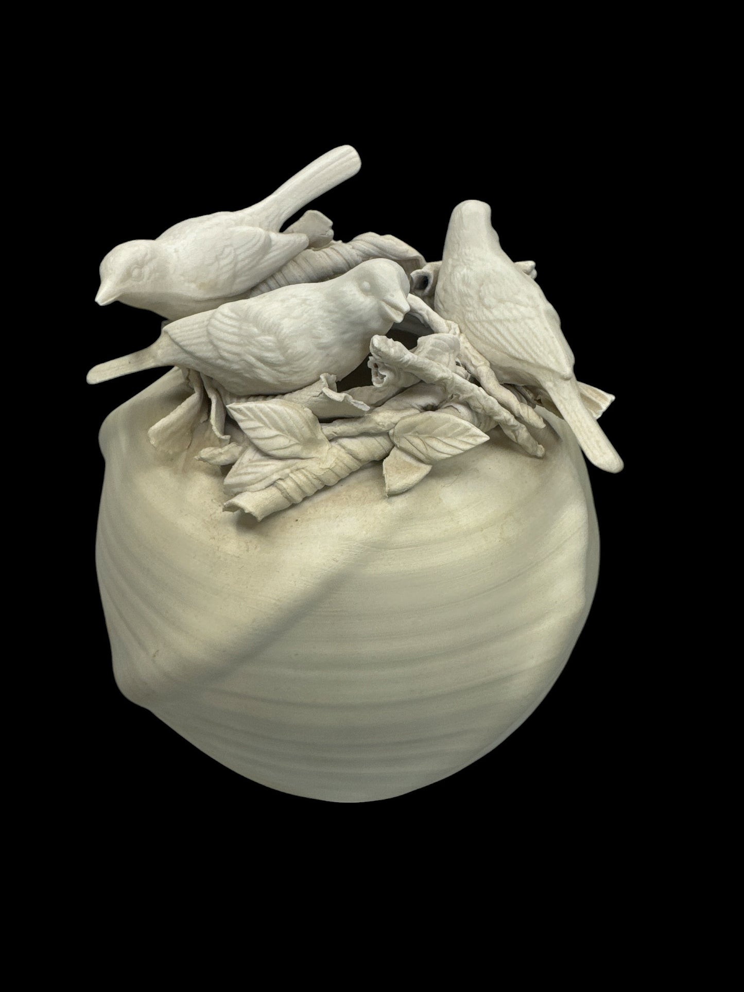 Actual Product Image - White ceramic sculpture of birds on a branch with leaves on a black background 