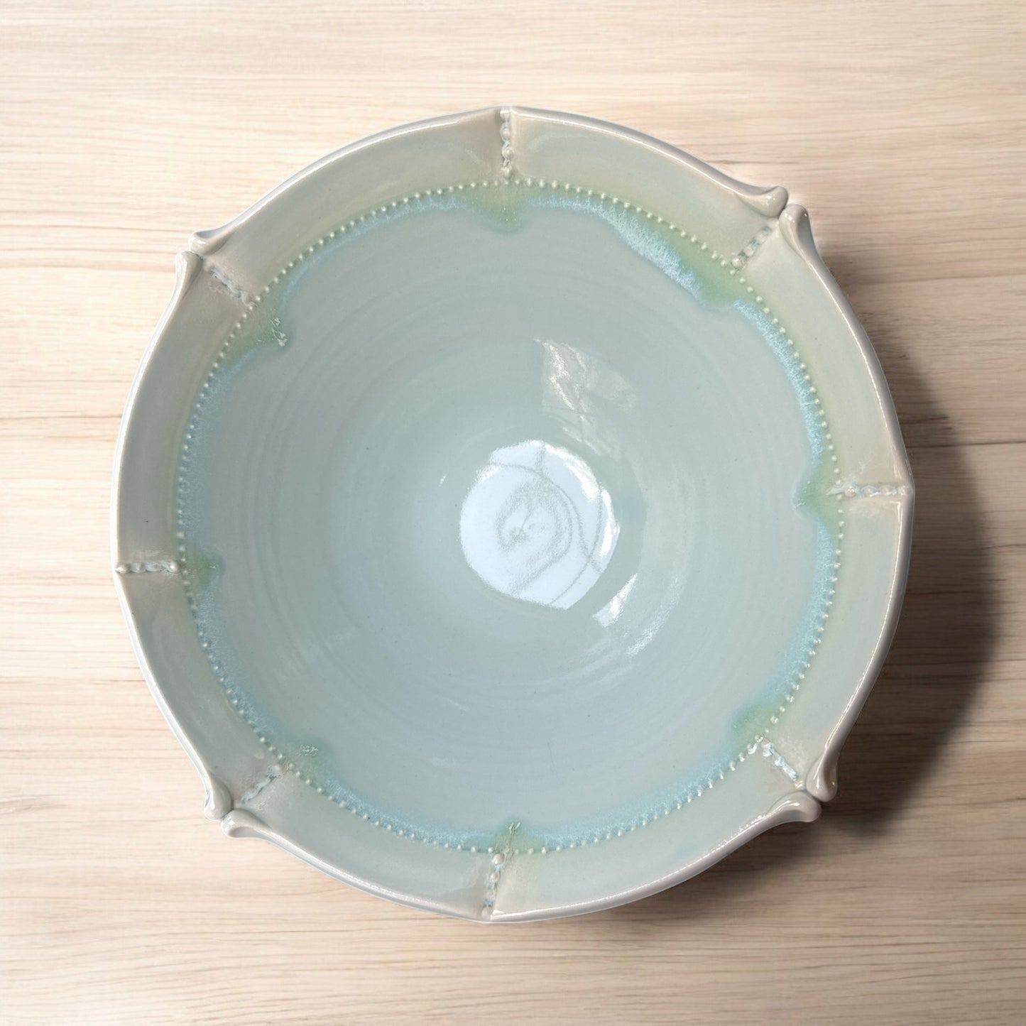Actual - Ceramic bowl with decorative rim on a wooden surface