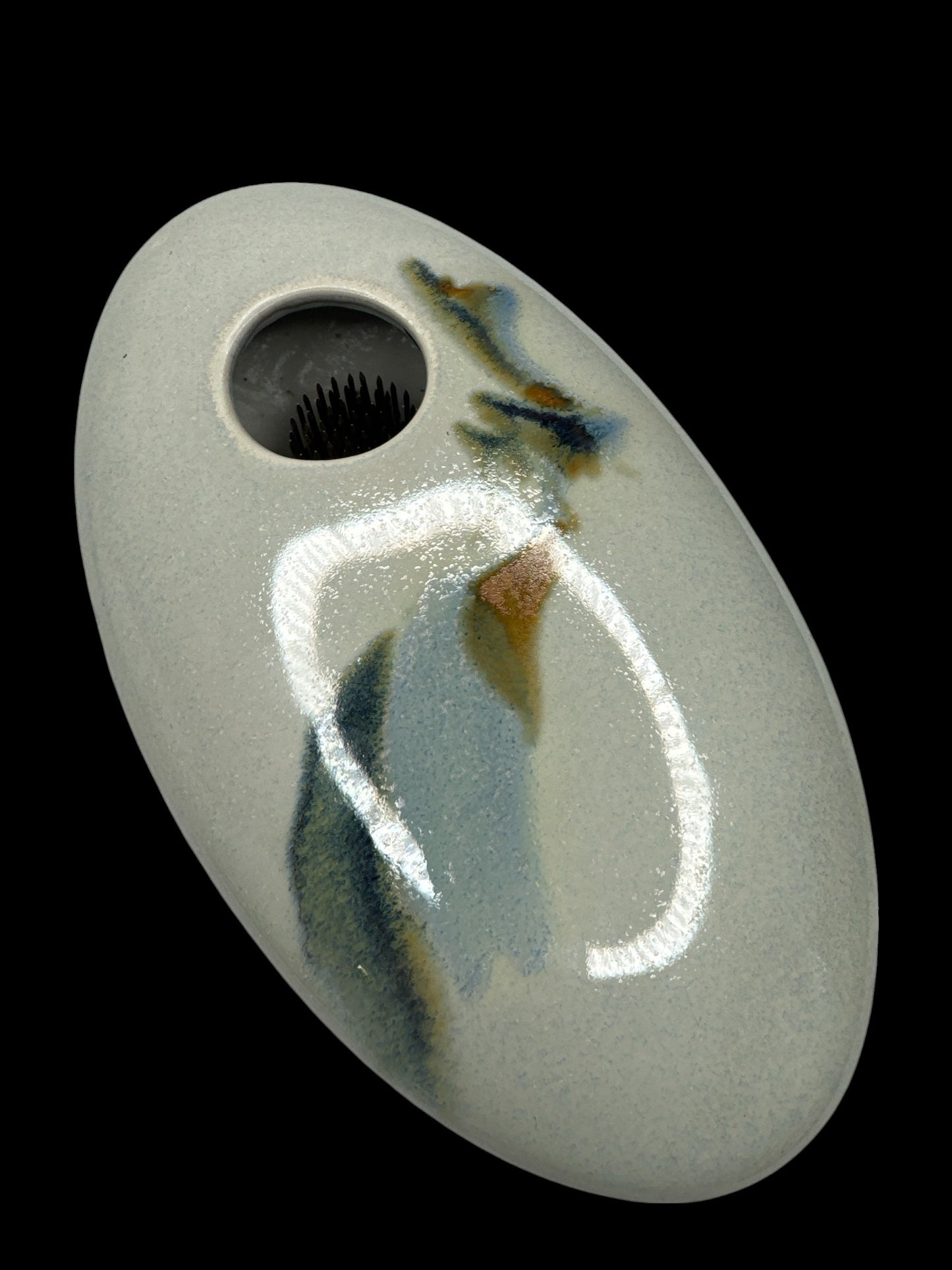 Actual Product Image - Ceramic pendant with a face design on a black background