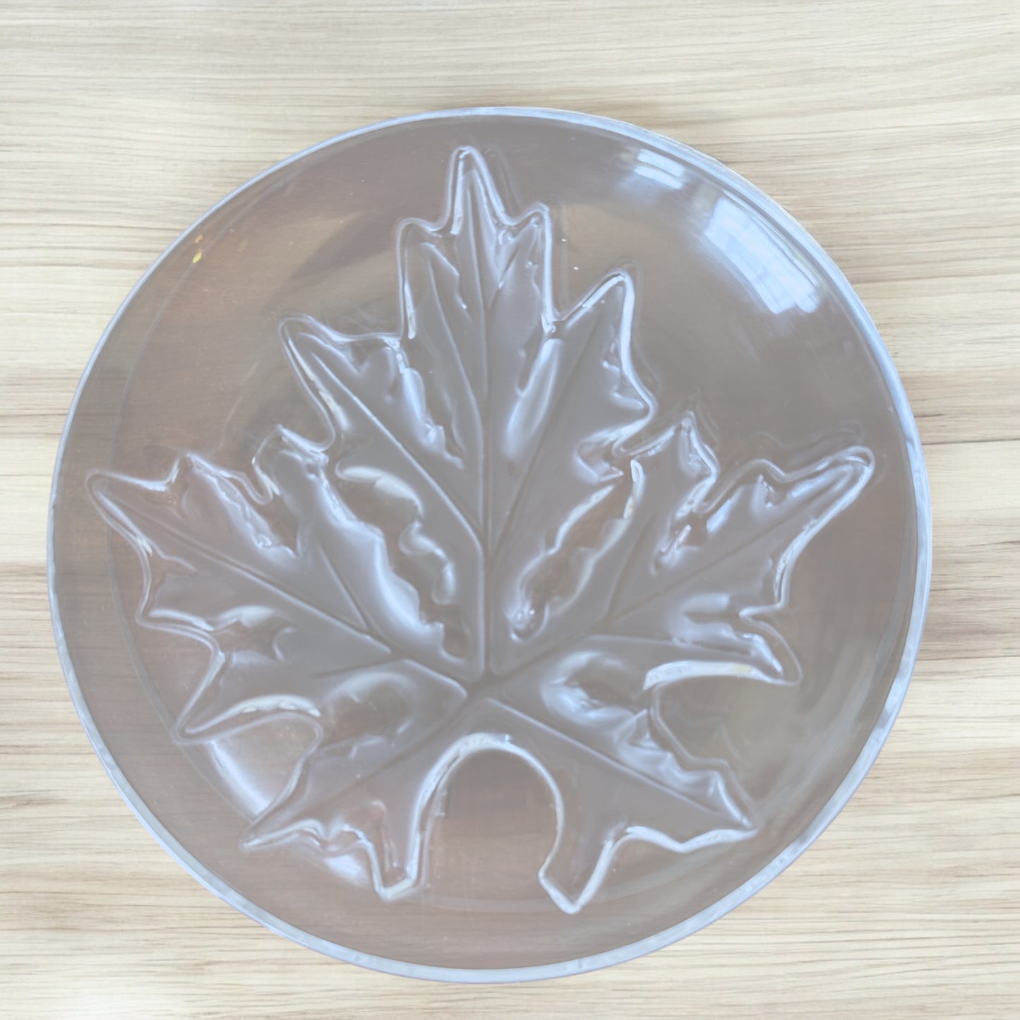 Actual Product Image - Clear plastic mold with a leaf design on a wooden surface